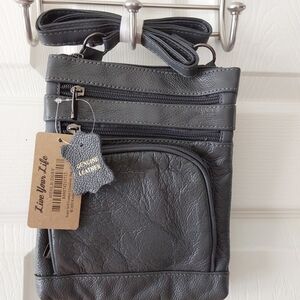Dark gray leather crossbody purse.